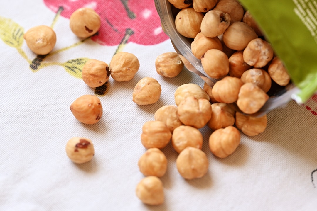 a bowl filled with nuts sitting on top of a table