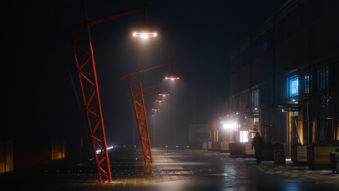 a person walking down a street at night