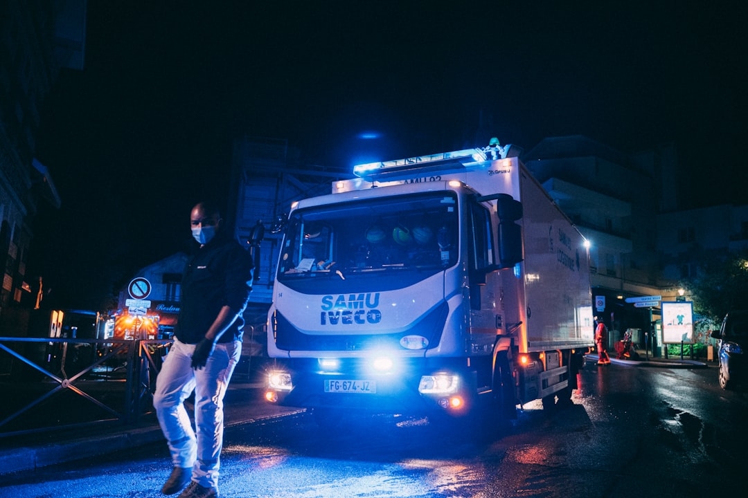 a man standing next to a truck on a street