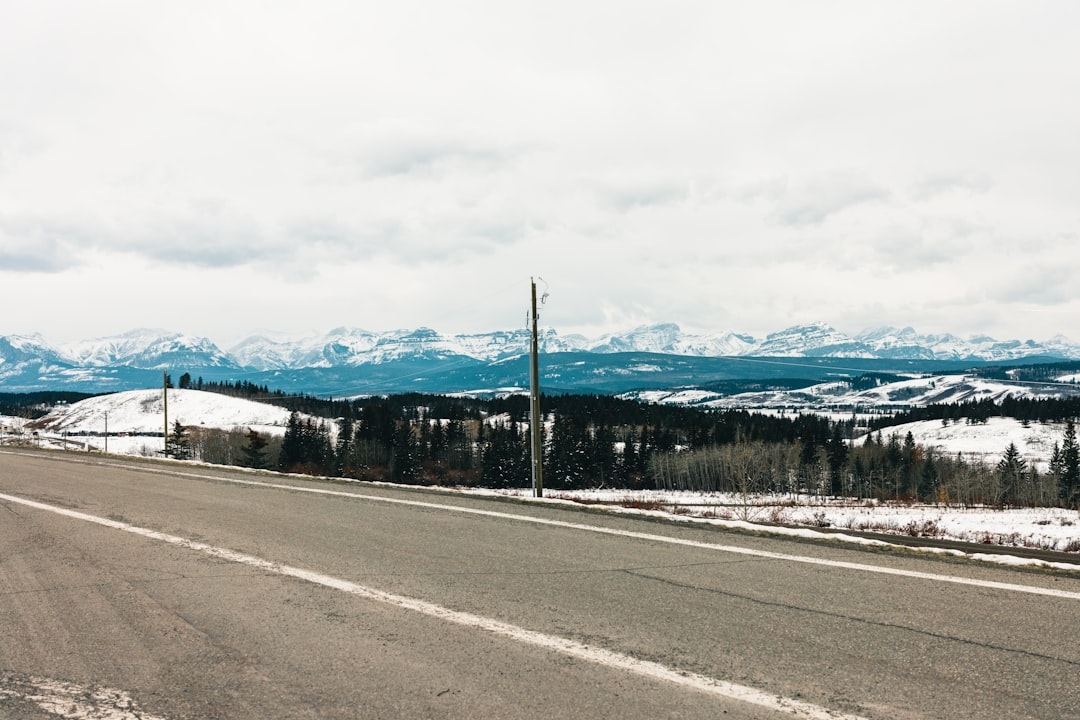 a road with snow covered mountains in the background