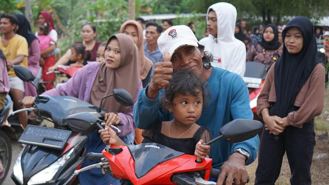 A group of people standing around a motorcycle