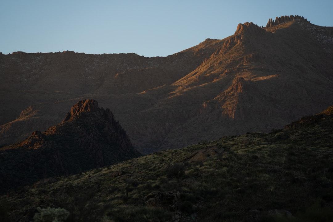 the sun is setting on a mountain range